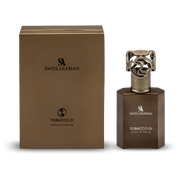 The Swiss Arabian Tobacco 01 Extrait De Parfum bottle stands beside its matching brown box, showcasing this bold unisex scent from Swiss Arabian.