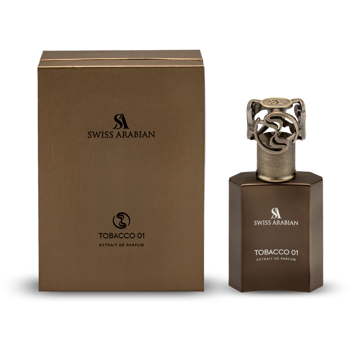 The Swiss Arabian Tobacco 01 Extrait De Parfum bottle stands beside its matching brown box, showcasing this bold unisex scent from Swiss Arabian.