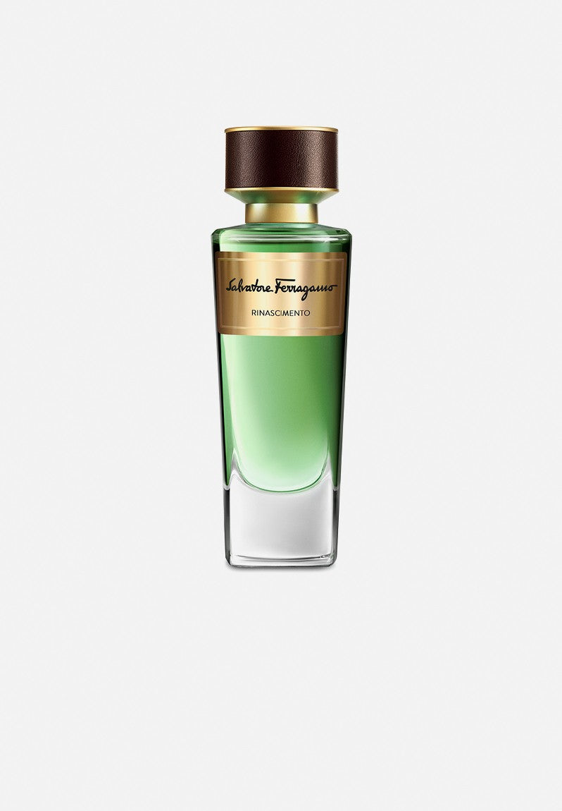A green glass bottle of Salvatore Ferragamo Rinascimento 100ml EDP, with a gold label and brown cap, sits on a white background—a sophisticated unisex perfume from Salvatore Ferragamo, celebrated for its refined floral scent.