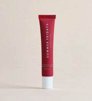 The Summer Friday Lip Butter Balm Cherry stands upright against a beige background, highlighting this nourishing lip mask for soft, hydrated lips.