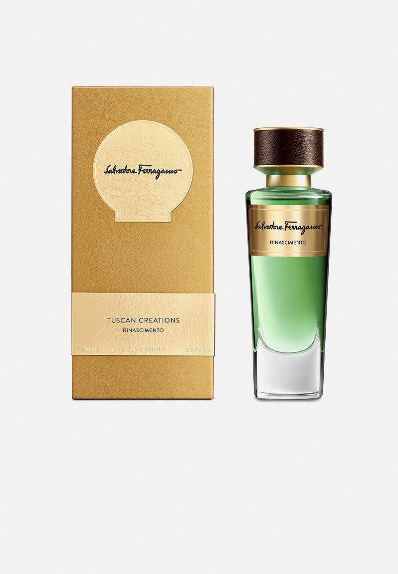 A gold box and a green glass bottle of Salvatore Ferragamo Rinascimento 100ml EDP by Salvatore Ferragamo are displayed side by side on a white background.