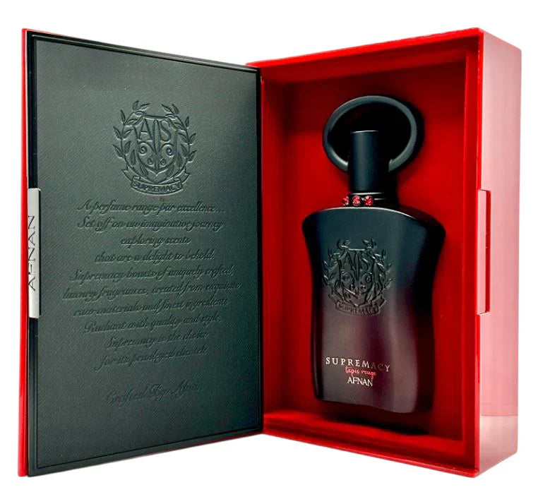 A black bottle of Afnan Supremacy Tapis Rouge 90ml EDP by Afnan, a floral fruity fragrance, is shown in a red box with embossed text inside the lid.