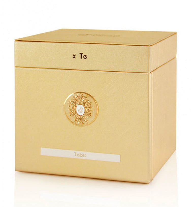 A gold square box with a decorative emblem and "Tiziana Terenzi Tabit 100ml Extrait De Parfum" on the front, set against a white background. A luxurious unisex fragrance by Tiziana Terenzi.