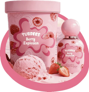 A bottle of Tubbees Berry Explosion EDP and a matching Tubbees ice cream tub are displayed alongside strawberries and a scoop of pink ice cream in the foreground, perfectly capturing the essence of this delightful mixed berry fragrance.