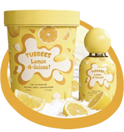 The Tubbees Lemon-A-Licious EDP bottle and box are displayed alongside lemon slices against a white background, highlighting the vibrant appeal of this unisex citrus fragrance from Tubbees. Experience how Tubbees Lemon-A-Licious Eau de Parfum delivers a zesty yet gourmand scent journey, making it an ideal choice for any occasion.