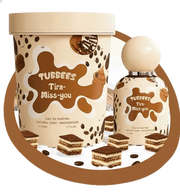 Two Tubbees Tira-Miss-You EDP bottles, one large and one small, are surrounded by tiramisu dessert pieces and coffee bean graphics on a white background, beautifully capturing the irresistible essence of this unisex fragrance from Tubbees—a must-have tiramisu-inspired eau de parfum for coffee scent enthusiasts.