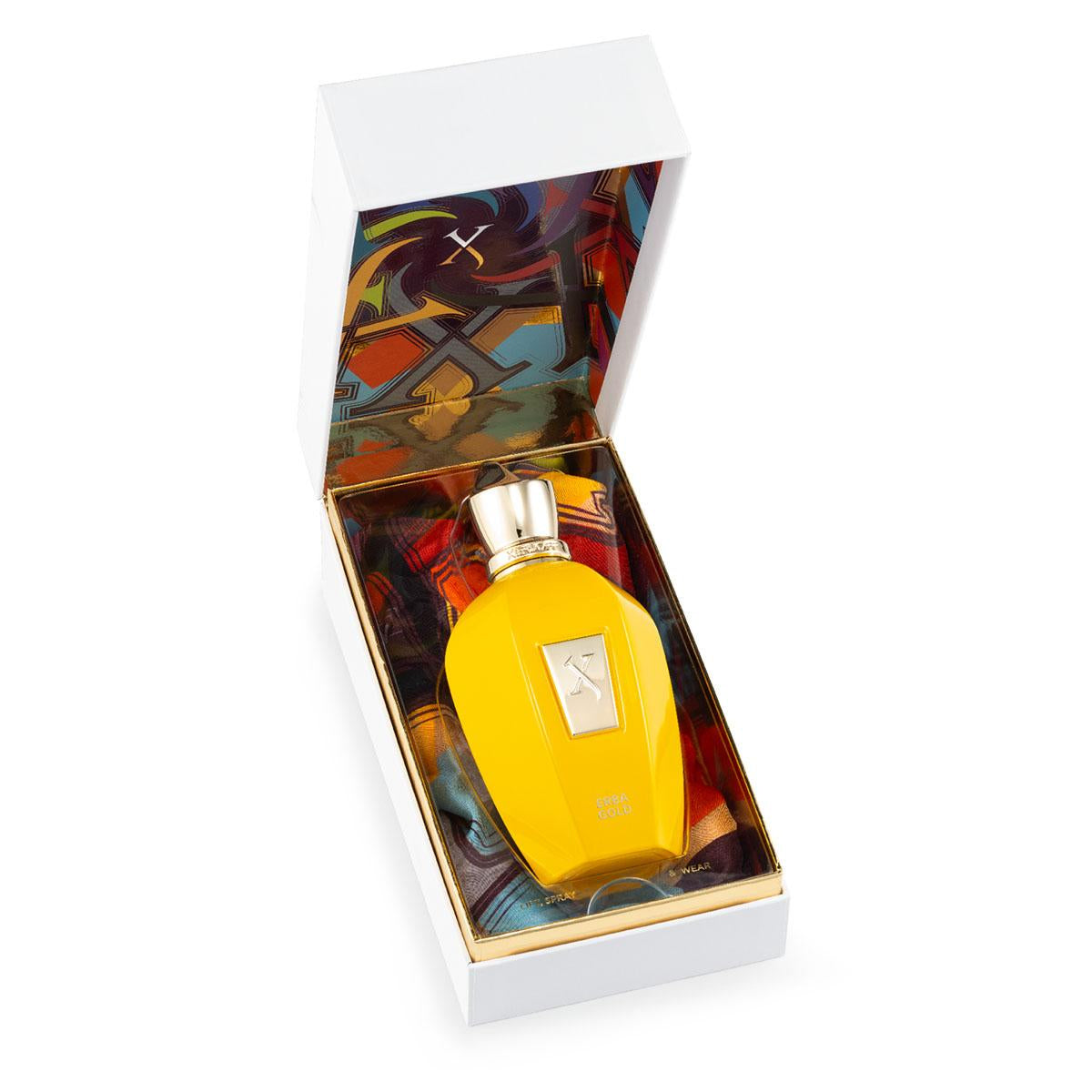 The Xerjoff Erba Gold 100ml perfume, housed in a yellow bottle with a gold cap, rests in an open white box with a colorful interior design. It's the essence of elegance, akin to unwrapping a luxury silk scarf.