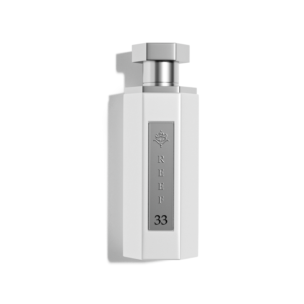 The Reef 33 White 100ml EDP by Reef is a white, hexagonal perfume bottle with a silver "REEF 33" label and rose symbol, shown on a plain white background to highlight this elegant unisex fragrance.