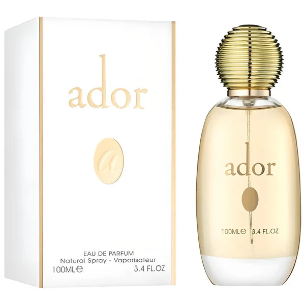 A clear glass bottle of Fragrance World Ador 100ml EDP, adorned with a ribbed gold cap, is displayed beside its sophisticated white and gold packaging. This elegant perfume for women by Fragrance World delights the senses with its radiant floral fruity fragrance.