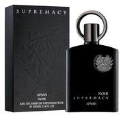 A 100ml black bottle of Afnan Supremacy Noir EDP by Afnan, a bold Oriental Spicy scent, is shown next to its sleek matching black box with silver lettering.