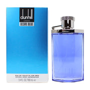 A blue box labeled “Dunhill Desire Blue” stands beside a corresponding 100ml Dunhill Desire Blue perfume bottle with a silver cap, highlighting this refreshing men’s fragrance known for its signature Aromatic Green notes.