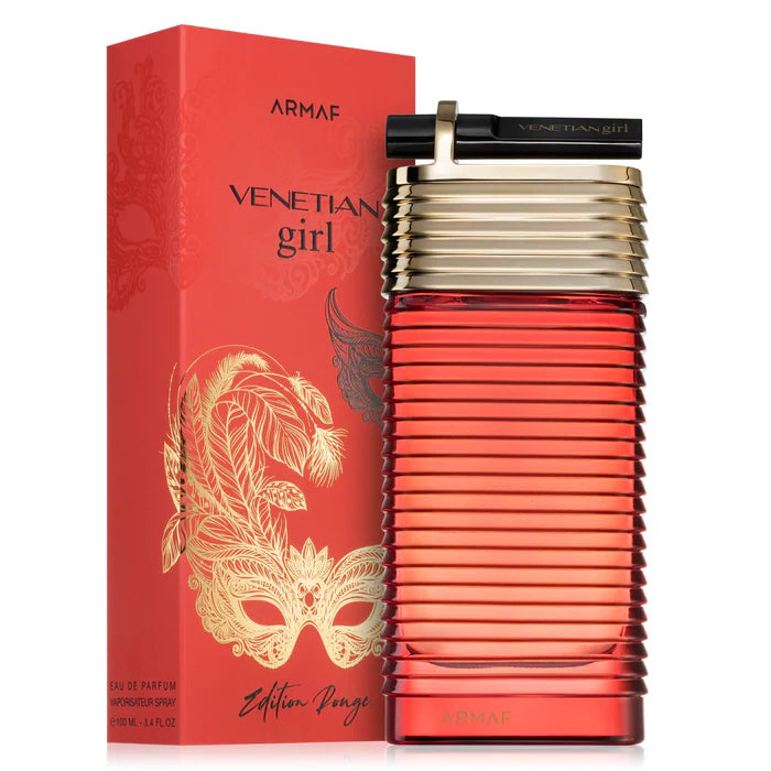 A striking red and gold bottle of Armaf Venetian Girl Edition Rouge 100ml EDP stands beside its matching box with a masquerade mask design—an alluring women’s fragrance from Armaf.