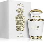 The Khadlaj Empire Victor 100ml EDP, a luxurious unisex fragrance by Khadlaj, is presented in a white and gold bottle beside its matching decorative box with gold patterns.