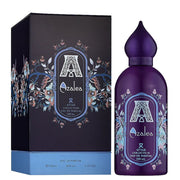 The Attar Collection Azalea 100ml Eau De Parfum, with its Oriental Vanilla scent and purple bottle, exudes elegance alongside a decorative box. Containing 80% vol, it reflects the exquisite allure of Crystal Love's captivating fragrances.