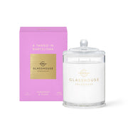 The Glasshouse A Tango in Barcelona 380g Soy Candle, a non-toxic soy candle in a lidded glass jar with tuberose & plum scent, comes in a pink and gold box—evoking wild peonies.