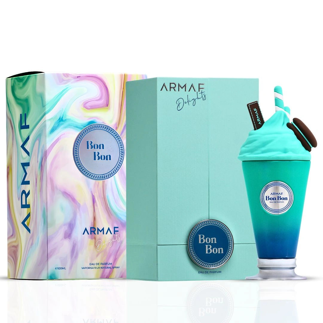 A bottle of Armaf Delights Bon Bon 100ml EDP by Rio Perfumes, shaped like a blue milkshake, sits beside its vibrant marbled and teal packaging—an eye-catching choice for fans of floral fruity gourmand scents.
