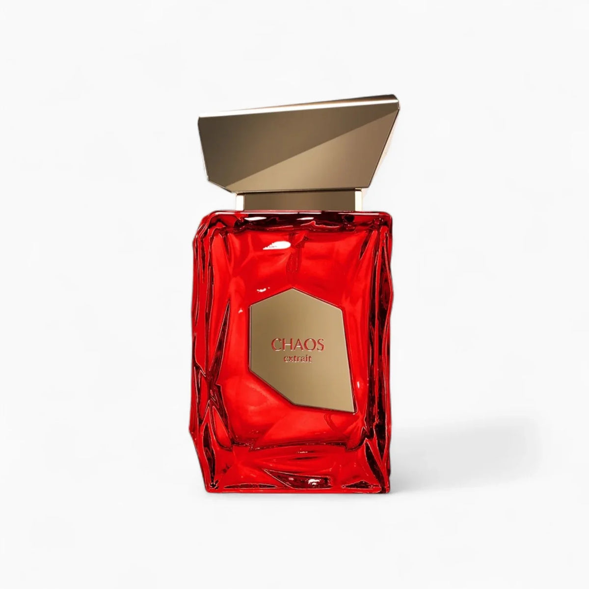 A red glass perfume bottle featuring a geometric gold cap and a gold label with “CHAOS extrait” on the front stands against a plain white background. The French Avenue Chaos Extrait 100ml Extrait De Parfum from French Avenue exudes the sophisticated allure of an elegant leather fragrance.