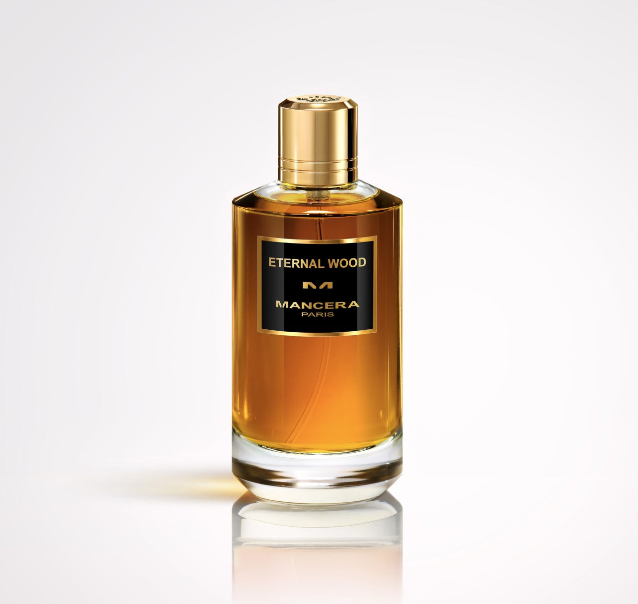 A bottle of Mancera Eternal Wood 120ml Eau De Parfum by Mancera, a luxurious unisex scent with amber liquid, gold cap, and black label, is displayed against a plain light background.