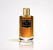 A bottle of Mancera Eternal Wood 120ml Eau De Parfum by Mancera, a luxurious unisex scent with amber liquid, gold cap, and black label, is displayed against a plain light background.