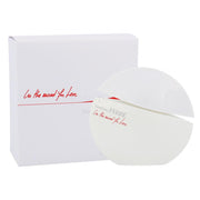 A white circular Gianfranco Ferre In The Mood For Love 100ml Eau De Parfum bottle with a slanted top stands beside a matching white box with red script, both featuring the Gianfranco Ferre brand.