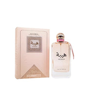 Ard Al Zaafran Heibah 100ml Eau De Parfum sits beside its beige and gold box, both adorned with Arabic script and patterns, reflecting the Oriental Floral essence of this Ard Al Zaafran fragrance.