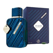 A 100ml Fragrance World Inizio For Him Eau de Parfum bottle by Rio Perfumes is shown next to its matching blue box packaging.