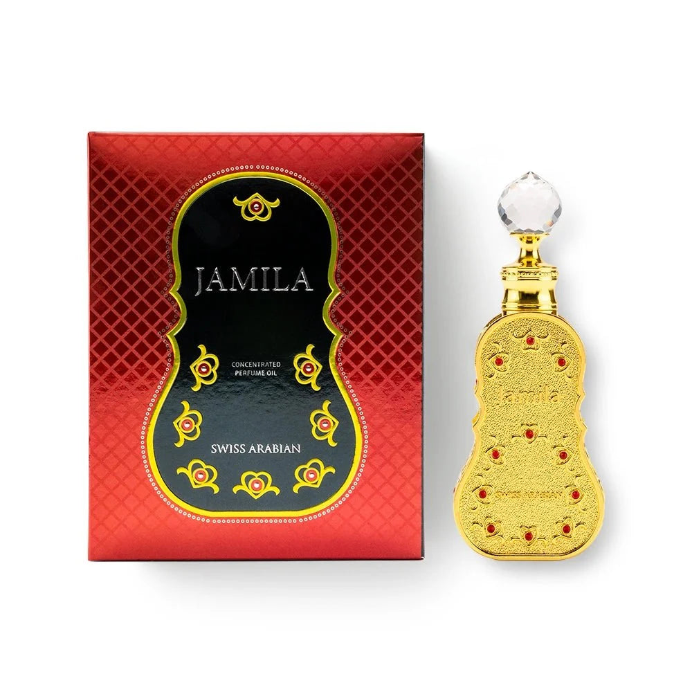 A red and black box labeled "Swiss Arabian Jamila" sits beside an ornate gold bottle of Swiss Arabian Jamila Concentrated Oil, topped with a faceted clear cap. Both the box and bottle showcase decorative red and gold accents, perfectly reflecting the luxurious allure of this amber floral fragrance from Swiss Arabian.