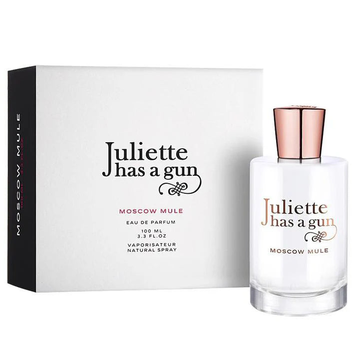 A 100ml bottle of Juliette Has a Gun Moscow Mule EDP is displayed beside its stylish white box, featuring black and copper accents.