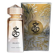 A Paris Corner Khair Felicity 100ml Eau De Parfum bottle sits next to its elegant gold and silver-accented box, highlighting the brand’s refined unisex fragrance.