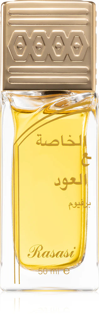 A clear glass bottle with a gold cap holds yellow Rasasi Khaltaat Al Khasa Dhan Al Oudh Eau De Parfum, a luxurious unisex oriental fragrance from Rasasi.