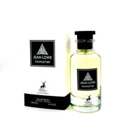 A 100ml bottle of Maison Alhambra Jean Lowe Immortel Eau De Parfum stands beside its matching white box, both adorned with black labels featuring white text and a tree motif, showcasing the brand’s elegant, refined aesthetic.