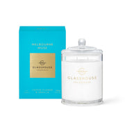 The Rio Perfumes Glasshouse Melbourne Muse Soy Candle 380g, with coffee flower and vanilla aromas, elegantly pairs with its turquoise box. Enhance your space with the Hamptons Diffuser in Teak & Petitgrain for a cohesive and sophisticated fragrance experience.