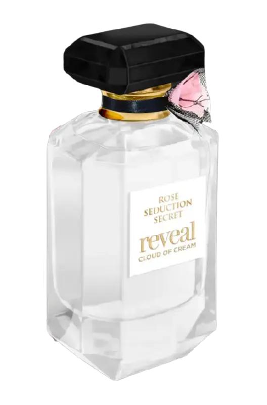 A clear glass bottle labeled "Fragrance World Rose Seduction Secret Reveal Cloud Of Crème 100ml EDP," featuring a black cap, small pink rose on the neck, and filled with an enticing oriental gourmand Eau de Parfum.