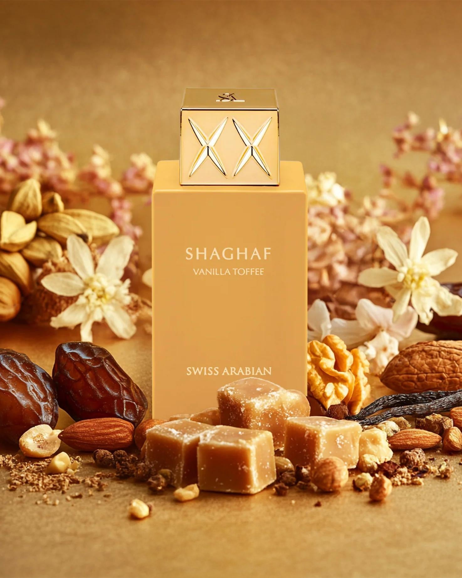 Swiss Arabian Shaghaf Vanilla Toffee EDP is displayed among toffee, dates, nuts, vanilla beans, and dried flowers on a golden background, capturing the sumptuous essence of an Oriental Vanilla fragrance.