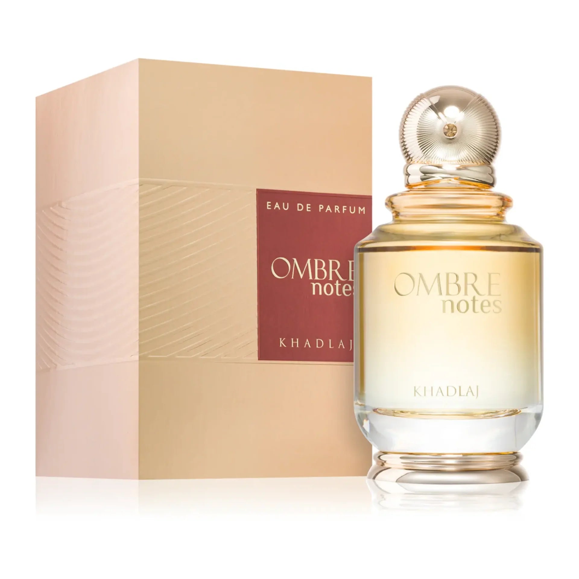A bottle of Khadlaj Ombre Notes 100ml EDP by Khadlaj is displayed beside its stylish beige and gold packaging.