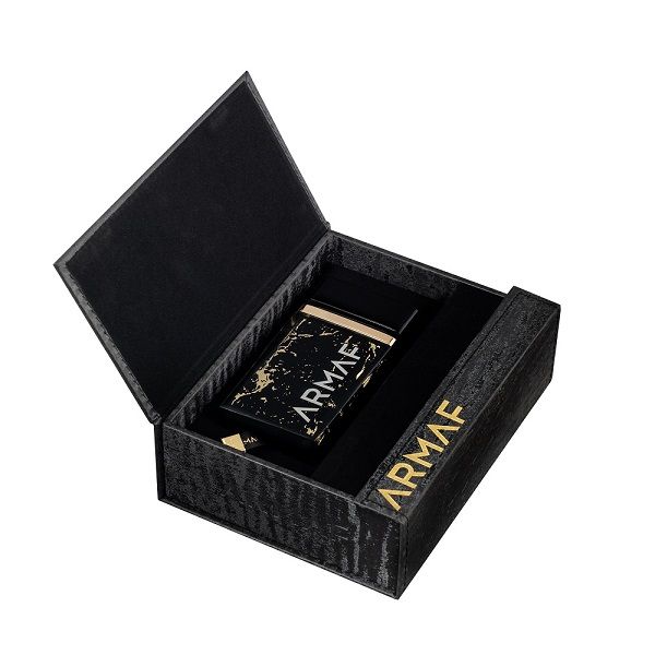 A black and gold Armaf Ombre D'or 75ml EDP (inspired by Crystal Saffron) unisex fragrance is displayed in an open black gift box with gold lettering.