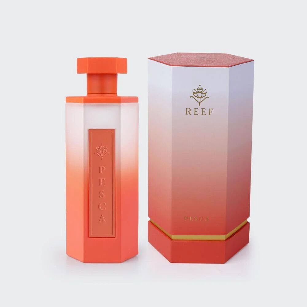 A hexagonal coral and white bottle labeled "Pesca" sits beside a matching "Reef" box on a light gray background, highlighting Reef Pesca 100ml Eau De Perfum by Reef, a refreshing unisex fragrance.