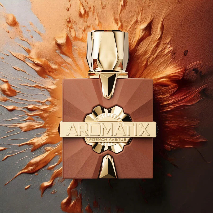 A gold-capped 100ml bottle of French Avenue Aromatix X Royal Taboo Extrait De Parfum rests among bronze and copper splashes, showcasing this alluring oriental woody unisex fragrance by French Avenue.