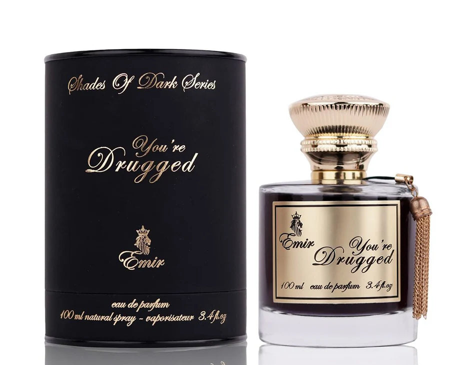 Emir's "You're Drugged" 100ml Eau De Parfum from the "Shades Of Dark Series" offers an aromatic spicy fragrance with cinnamon and whiskey notes, packaged in a matching cylindrical box to captivate the senses.