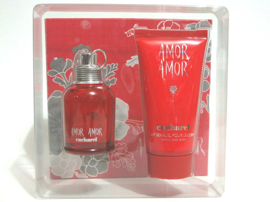 A bottle of Cacharel Amor Amor perfume, specifically the Cacharel Amor Amor 100ml Eau De Toilette Set, and a tube of cream.