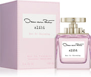 A bottle of Oscar de la Renta Alibi Eau So Charming 100ml EDT is shown beside its matching pink box.