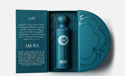 A teal Gissah Akoya 200ml EDP bottle rests in an open, decorative box featuring English and Arabic text inside—a luxurious unisex fragrance by Gissah.