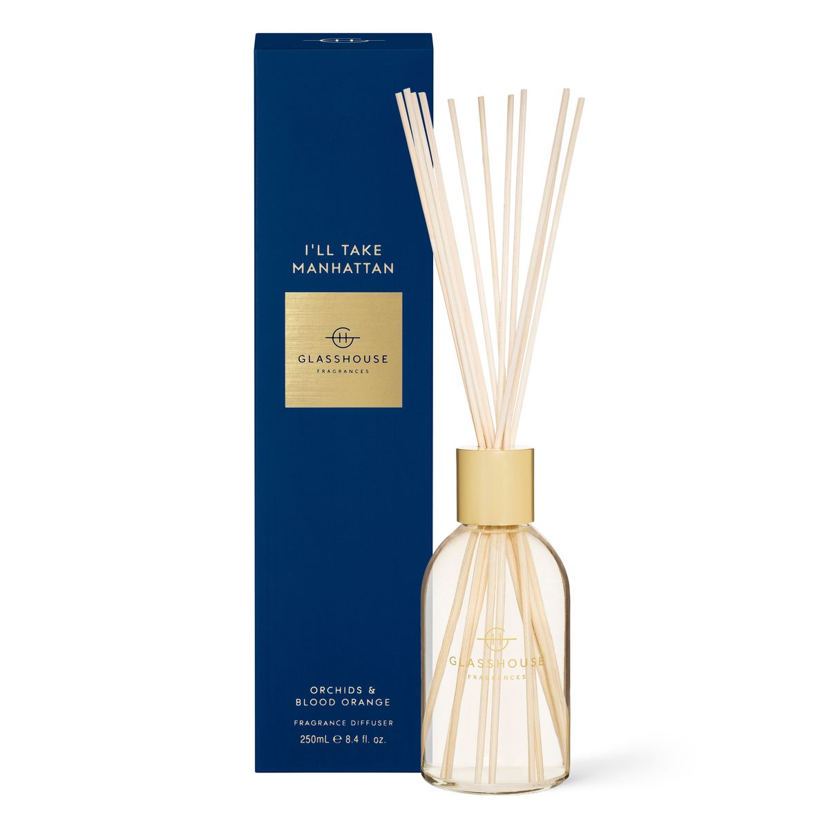 The Rio Perfumes "I'll Take Manhattan" Glasshouse diffuser, featuring reeds and the "Orchids & Blood Orange" scent, comes elegantly packaged in a striking blue box.