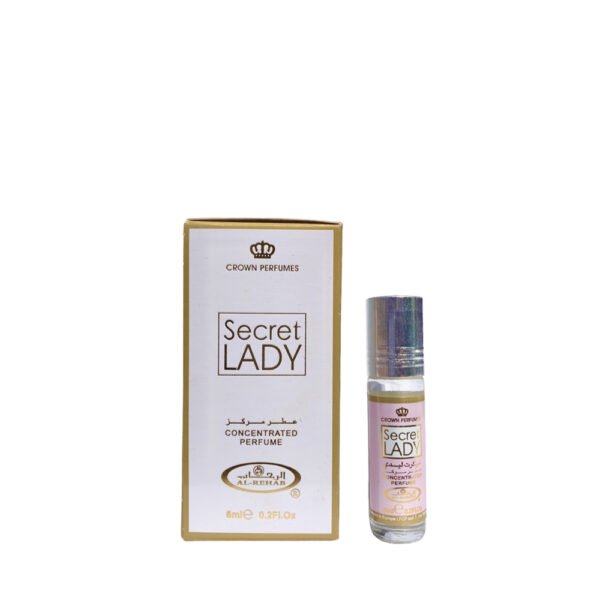 A small bottle of Crown Perfumes Al-Rehab Secret Lady concentrated oil perfume is shown next to its elegant white and gold packaging.