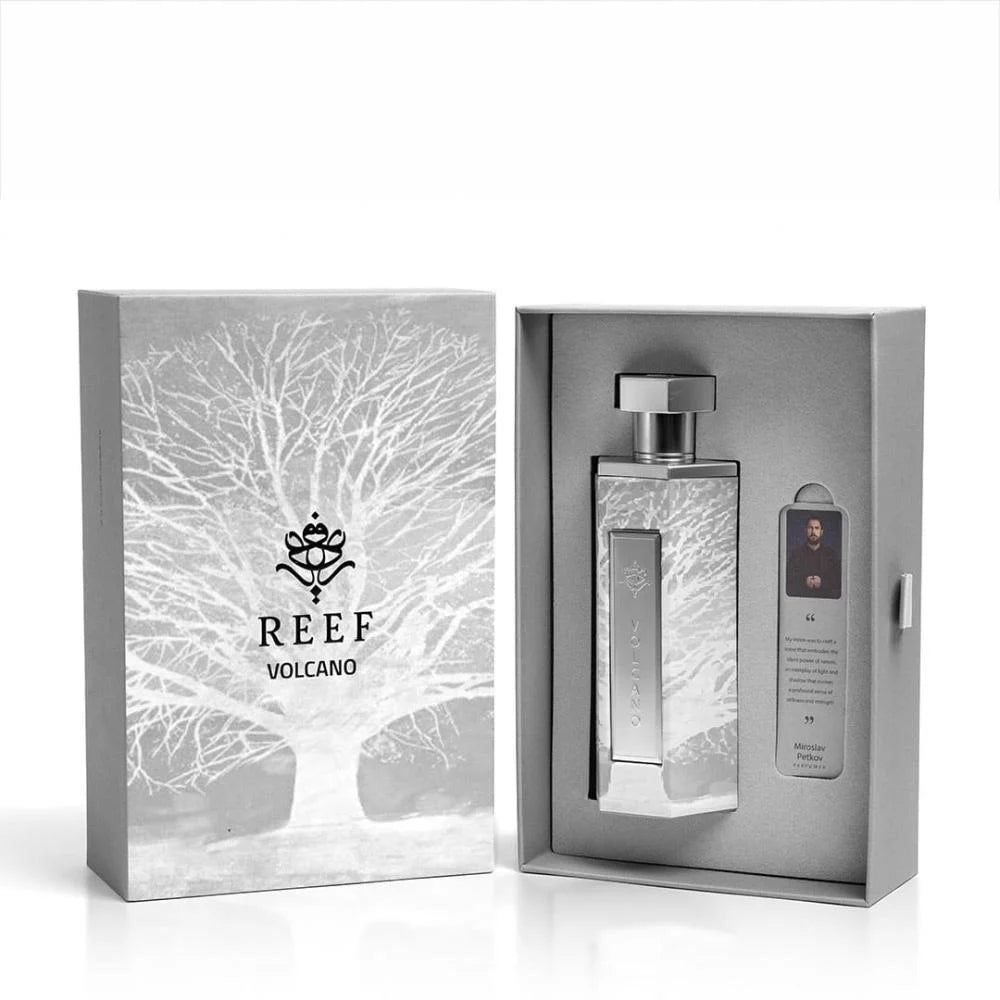 The Reef Volcano 200ml EDP boxed set features a unisex fragrance by Reef in a rectangular glass bottle, an informational card, and comes in a gray box with a white tree design.