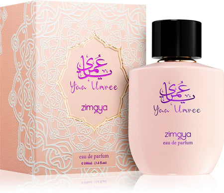A 100ml bottle of Zimaya Yaa Umree EDP by Zimaya is displayed beside its ornate pink and gold box, both featuring Arabic and English text. This Oriental Floral scent radiates elegance and charm.