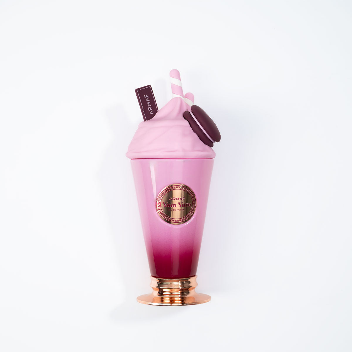 A playful pink and purple milkshake-shaped bottle with a swirl lid, straws, chocolate accent, and metallic base holds Armaf Delights Yum Yum 100ml EDP—a cheerful women’s fragrance from Armaf.