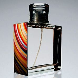 A vibrant Rio Perfumes bottle of Paul Smith perfume with a colorful stripe on it.
