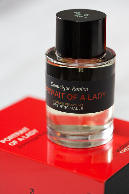 A Frederic Malle Portrait of a Lady 100ml Eau de Parfum by Dominique Ropion and Frederic Malle, sitting on top of a box.