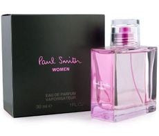 A pink "Paul Smith 100ml EDP" perfume bottle emits a delightful floral scent, sitting beside its black box packaging featuring pink text.